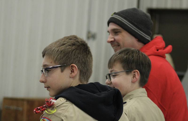 Rueben Arnold watches the pinewood derby cars race Saturday, Feb. 11, 2023, as part of the Cub Scout Pack 85 Derby at Bethel Evangelical Congregational Church in Dixon. Arnold served as a proxy racer for his son, Ayden, who is unable to attend as he is recovering from a bone marrow transplant. The race was recorded on video so Ayden could watch his car's race later.