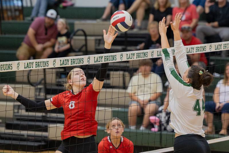 Grace Longmire (8) of Woodland tips ball over net as Hanna Waszkowiak (44) of St. Bede jumps to its defense on Thursday, Sept. 11, 2025 at Abbot Vincent Gymnasium in Peru.
