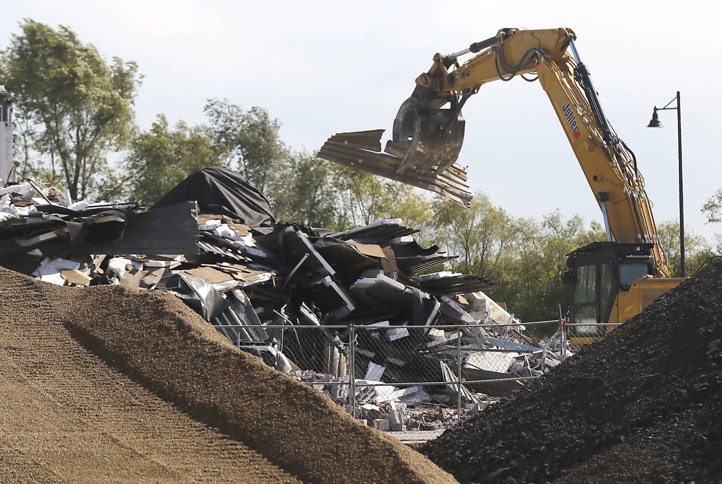 A building is removed as work continues on the site of the Water’s Edge development on Wednesday, Oct. 18, 2023, before the groundbreaking event for the development that will include new commercial buildings, townhomes and apartments.
