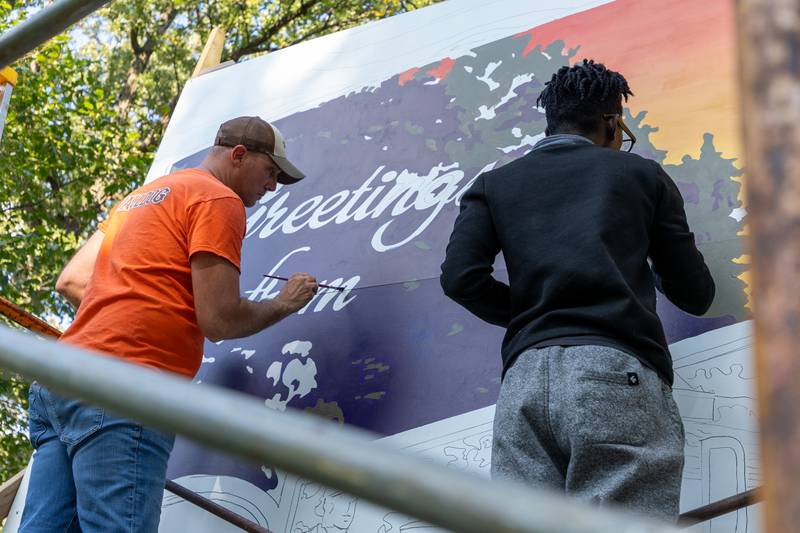 Curt Bedei and Nate Petit-Dieu of the Walldogs paint Streator mural standing on scaffolding on Thursday, Sept. 11, 2025 at City Park in Streator.