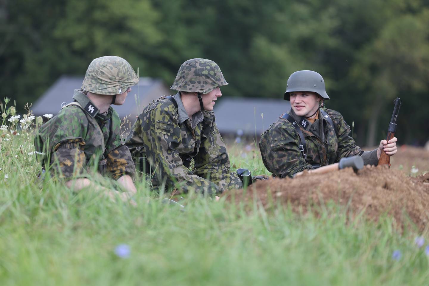 German soldiers sit at a trench before the start of the WWII battle re-enactment at Lockport Military History Days at Dellwood Park on Saturday, Sept. 9, 2023 in Lockport.