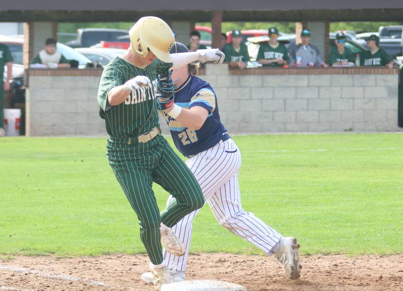 Marquette's Braxton Nelle tags out St. Bede's Geno Dinges at first base on Tuesday, April 28, 2026 at Masinelli Field in Ottawa.