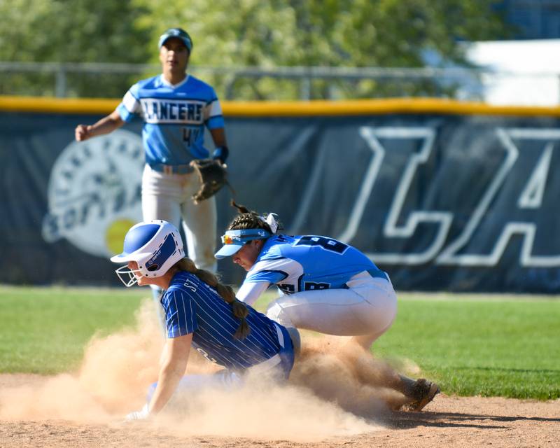 St. Charles North's Haley Nelson, left, slides into second base safely as Lake Park's Tea Picardi (88) tries to put on the tag during the game on Wednesday April 24, 2024, held at Lake Park High School.