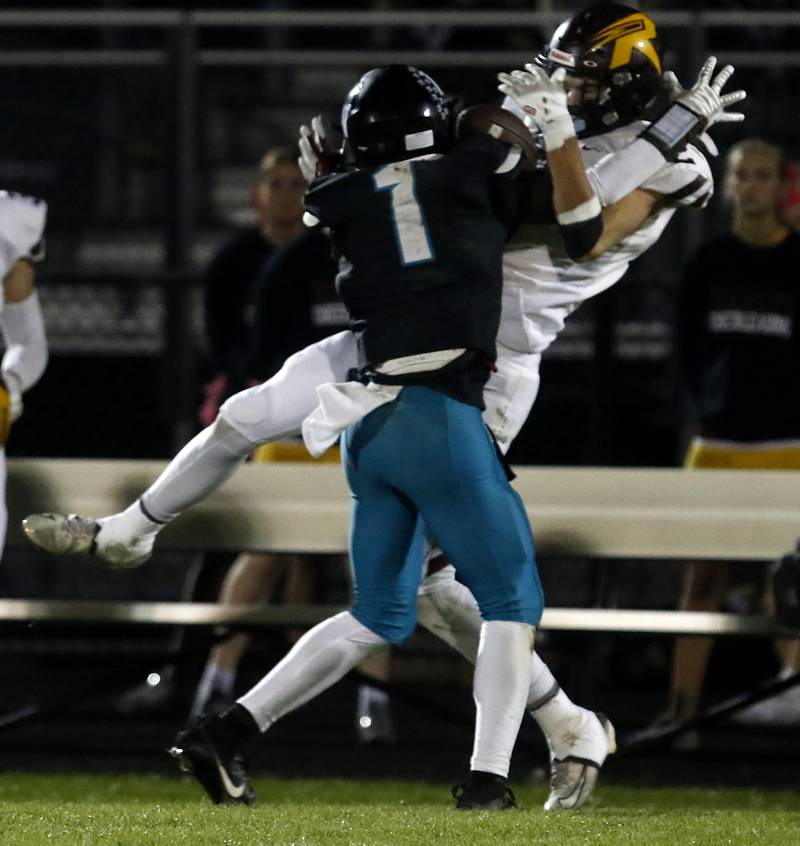 Woodstock North's Jr Fadahunsi hits Richmond-Burton's Jace Nelson as he tries to catch the ball during a Kishwaukee River Conference football game on Friday, Oct. 10, 2025, at Woodstock North High School. Fadahunsi was called for pass interference not eh play.