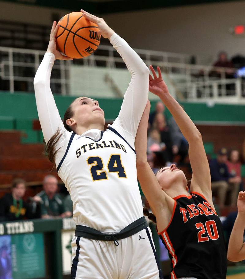 Sterling's Madison Austin grabs a rebound over Crystal Lake Central's Hadley Ferrero during their Class 3A sectional semifinal game Tuesday, Feb. 25, 2025, at Boylan Catholic High School in Rockford.