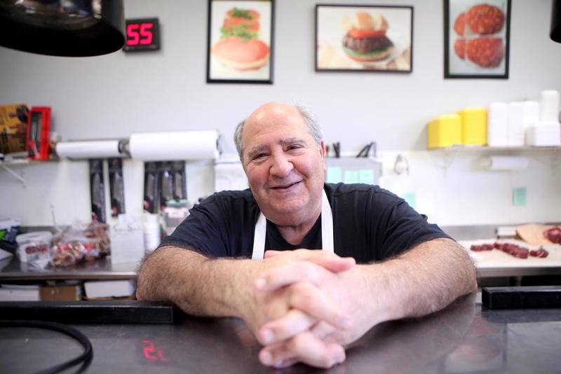 Owner Pat Falcone behind the counter at Josef's Elegante Meats and Deli.