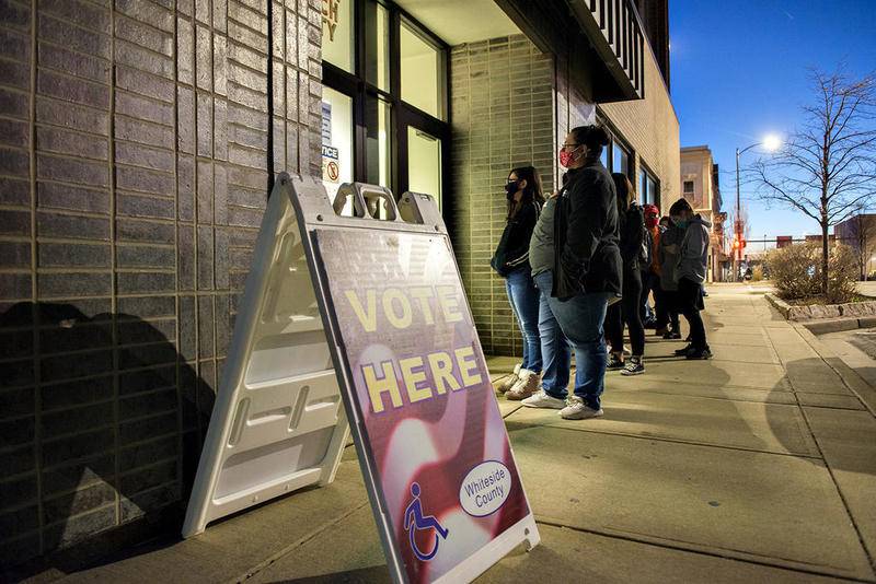 Voters line up outside of the Whiteside County Courthouse in Sterling Tuesday evening, waiting to vote in the general election.