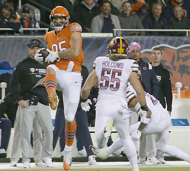 Chicago Bears tight end Cole Kmet (85) makes a catch over Washington Commanders linebacker Cole Holcomb (55) on Thursday, Oct. 13, 2022 at Soldier Field.