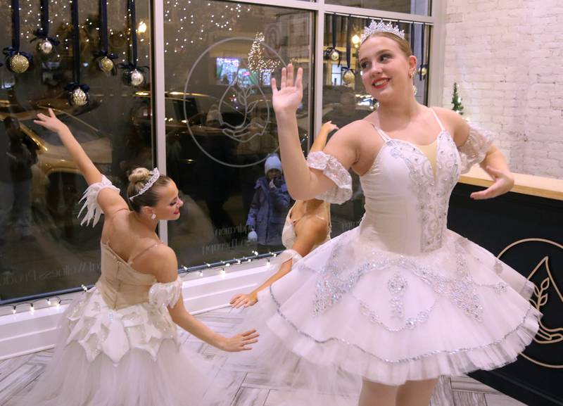 Elianna Oleksyn, (left) 15, Maddy Shannon, 16, and Regan DeBarba, (right) 16, from the Beth Fowler School of Dance, perform in a store window Friday, Nov. 22, 2024, during Moonlight Magic in downtown Sycamore.
