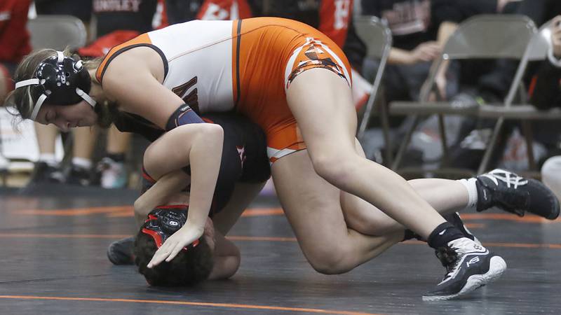 McHenry’s Addison Hodges tries to control Huntley’s Parker Chase during the 120-pound match of a Fox Valley Conference girls wrestling match Thursday, Jan. 11, 2024, at McHenry High School.