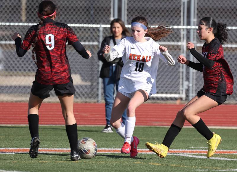 DeKalb's Arianna Weishaar splits two Rockford East defenders during their game Tuesday, March 25, 2025, in the Barb Fest tournament at DeKalb High School.