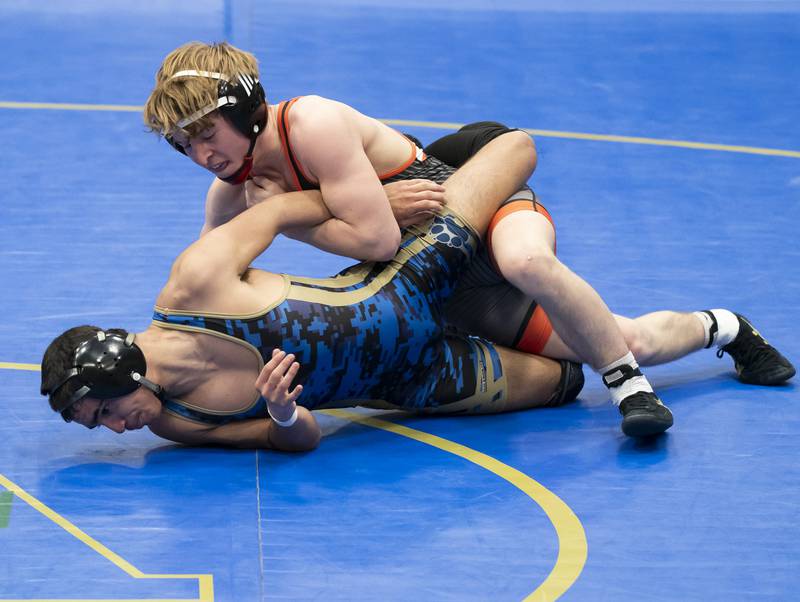 Crystal Lake Central's Dylan Ramsey, top, wrestles with Wheeling's Joey Romano in the 126 pound bout at the Class 2A Dual Team wrestling Sectional on Tuesday, February 25, 2025 at Wheeling High School. Ryan Rayburn for Shaw Local