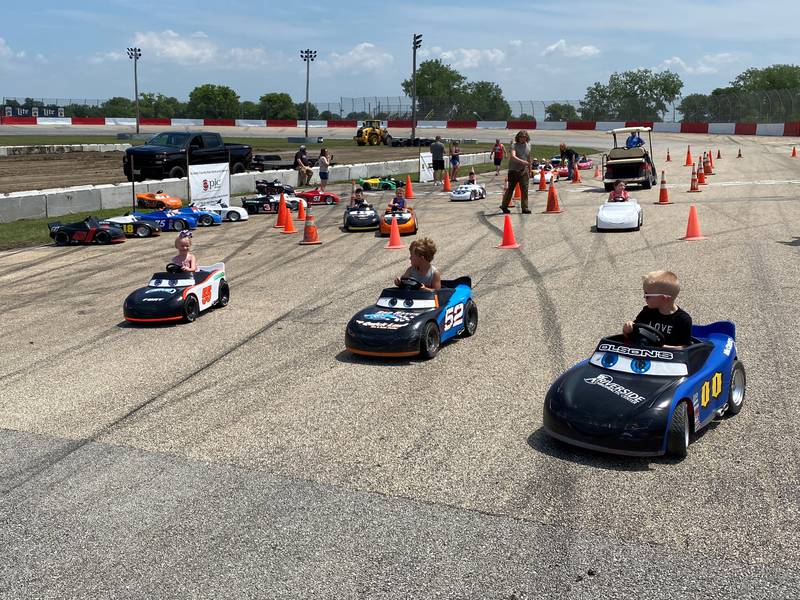 Kids break through the cones that make up the track at the Grundy County Speedway, zooming off into the rest of the raceway.