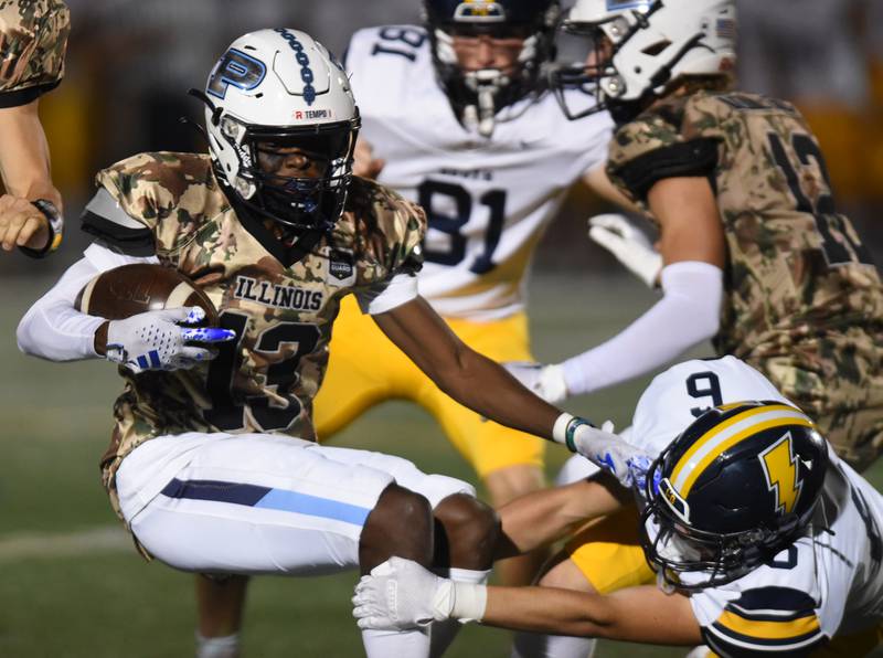 Joe Lewnard/jlewnard@dailyherald.com
Prospect’s Jaylen Calhoun, left, gets tackled by Glenbrook South's Landon Hooten during Thursday’s game in Mount Prospect.