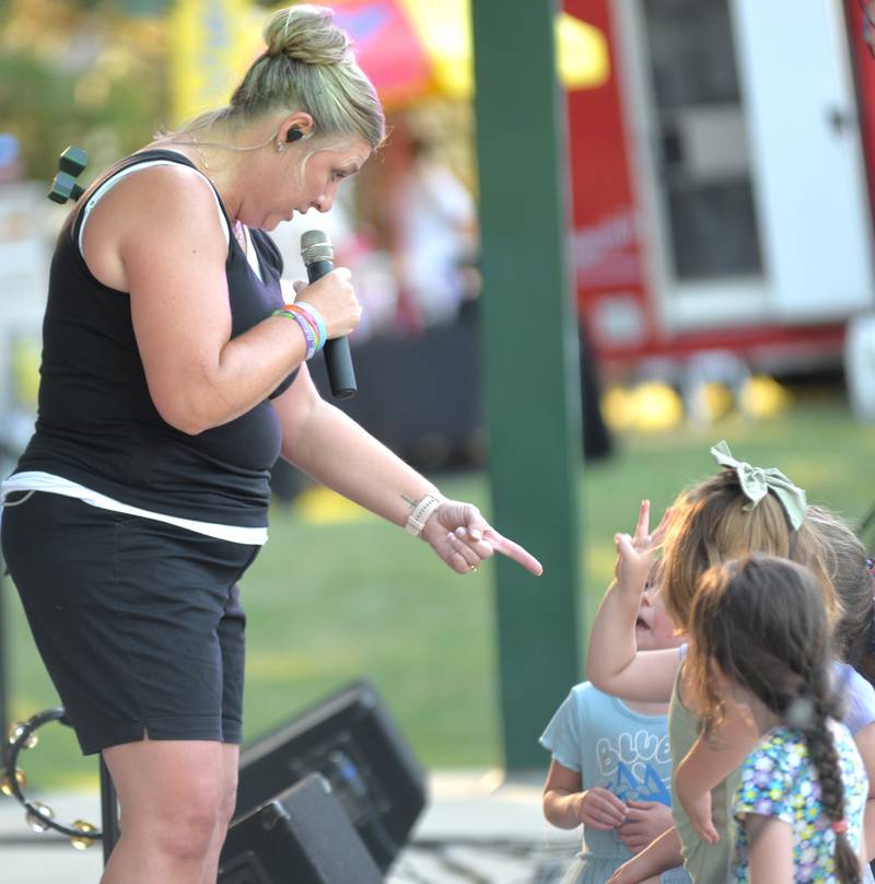 The lead singer for The 80s Hit List band talks to kids at the Oregon Park District's Concert in the Park on Tuesday, July 1, 2025 at Oregon Park West.