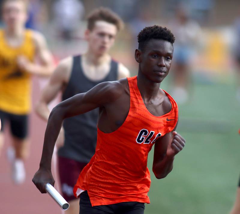 Crystal Lake Central’s Oliver Lavaty carries the baton in the 3200-meter relay in Fox Valley Conference boys track and field meet action at Huntley High School in Huntley on Thursday, May 15, 2025.