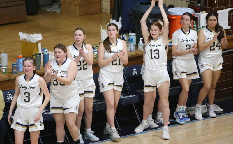 Members of the Marquette girls basketball team cheer on the Lady Crusaders as they play Roanoke-Benson on Thursday, Feb. 6, 2025 in Bader Gym at Marquette High School.