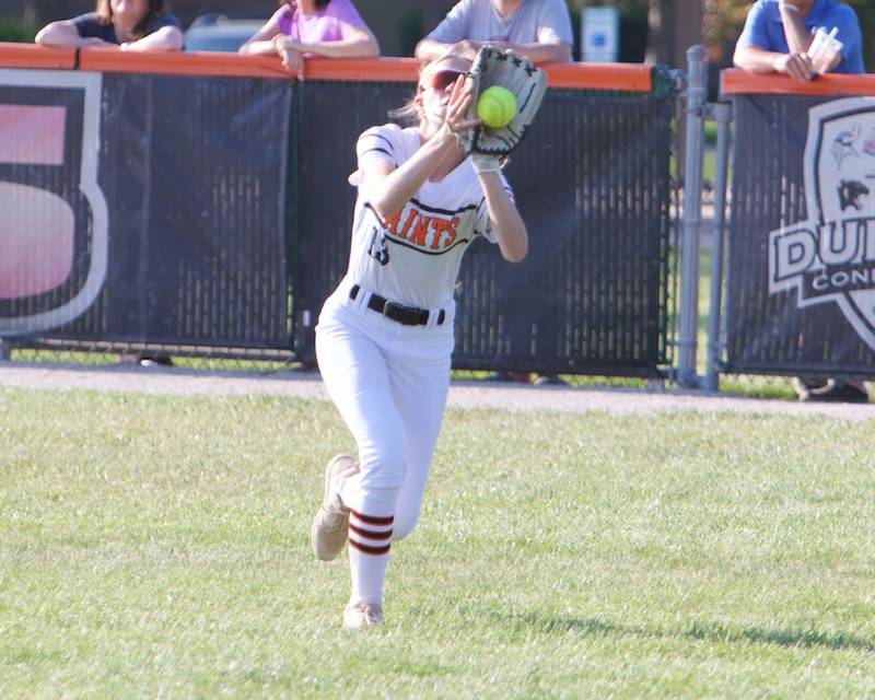 St. Charles East's Morgan Beers makes a running catch attempt against St. Charles North on Wednesday May 14,2025 in St. Charles.