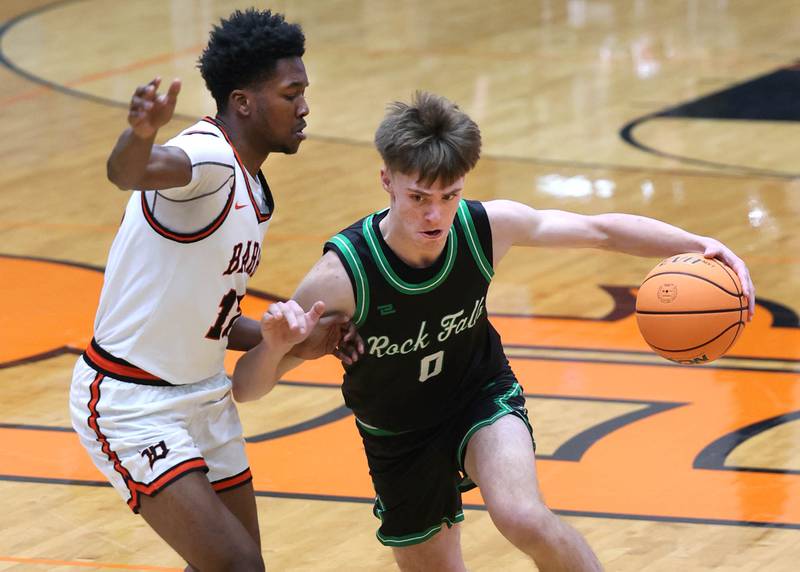 Rock Falls' Max Burns tries to drive by DeKalb's Derrion Straughter during their game Tuesday, Dec. 2, 2025, at DeKalb High School.
