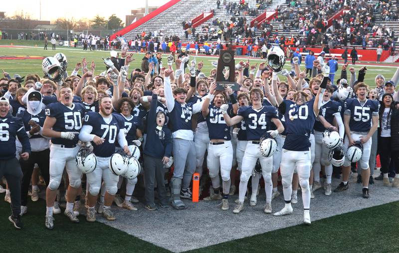 The Cary-Grove football team with the trophy Saturday, Nov. 25, 2023, after their win over East St. Louis in the IHSA Class 6A state championship game in Hancock Stadium at Illinois State University in Normal.