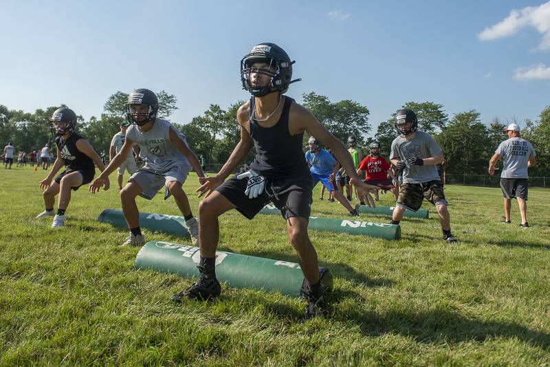 Rock Falls football camp members run through stretching drills Tuesday, July 19, 2022. Players of all ages attended the camp ahead of the upcoming season.