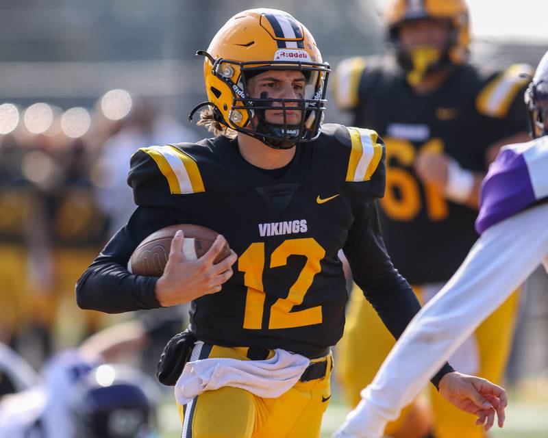 St Laurence's Evan Les (12) scrambles during Class 4A second round playoff football playoff game between Dixon at St Laurence.  Nov 4, 2023.