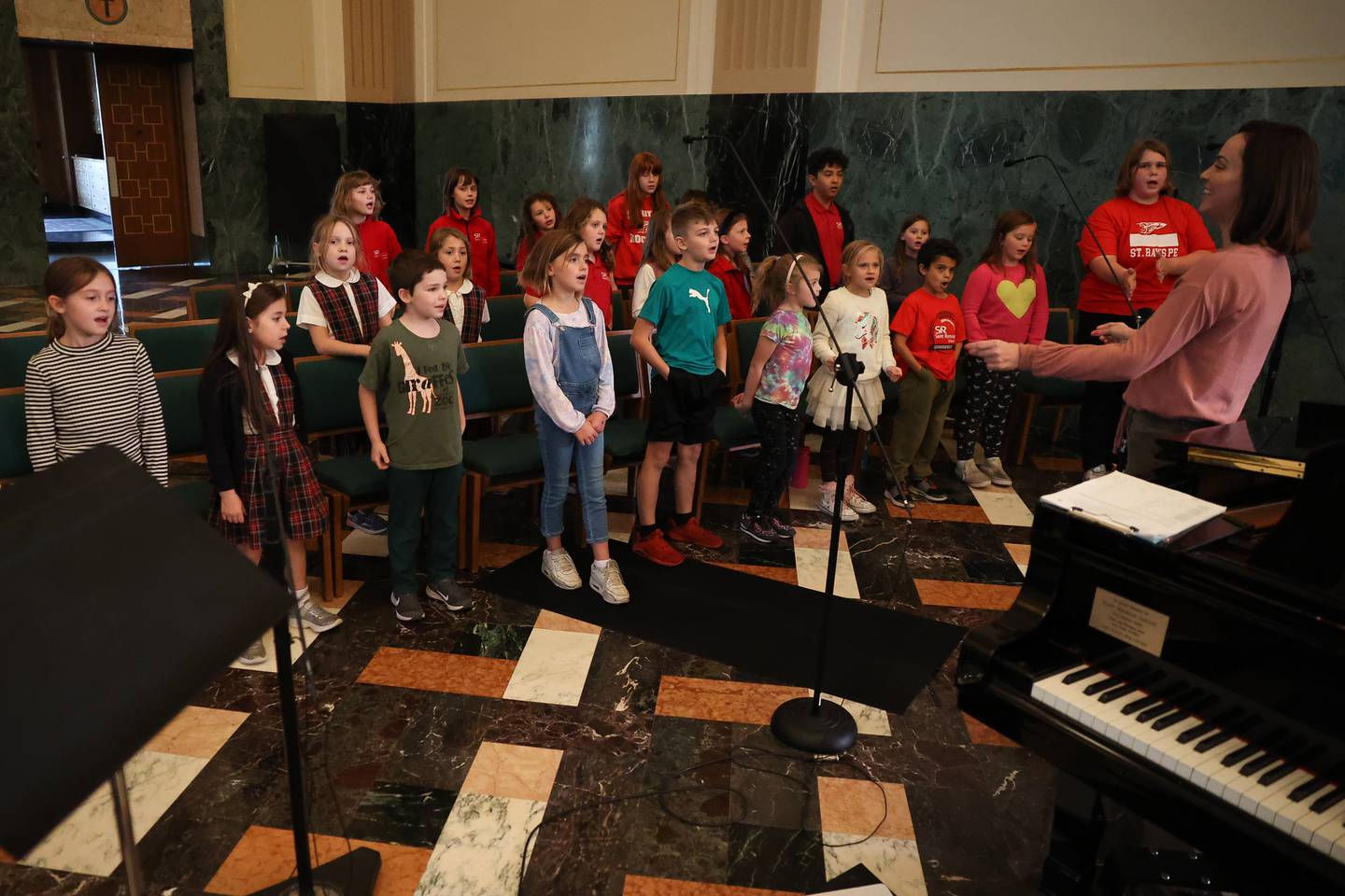 Stacy Sienko leads the children’s choir rehearsal at the Cathedral of Saint Raymond Nonnatus for the upcoming A Very Rialto Christmas show.