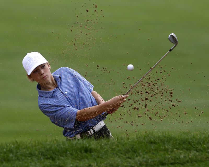 Burlington Central’s Tyler Samaan hits out of the sand trap onto the seventh green during the Fox Valley Conference Boys Golf Tournament Thursday, Sept. 21, 2023, at McHenry Country Club in McHenry.
