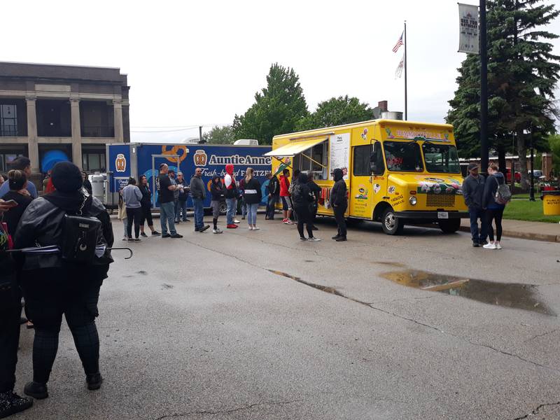 Streator Food Truck Festival goers gather in lines at Burritoville, one of the more popular trucks at the Saturday, May 21, 2022, event in City Park.