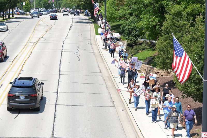 An estimated 1,200 people march from Elmhurst City Hall to Glos Memorial Park and back while participating in the nationwide No Kings Day Rally Saturday June 14, 2025.