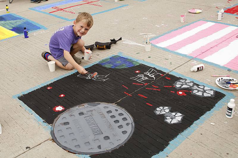 Logan Hess, 6, used his creativity to work with his assigned square on Saturday, Sept. 20, 2025, for Morrison's Paint the Town event. He was assigned a piece of the street that had a manhole cover, so he used it as inspiration to create his Star Wars Death Star scene.