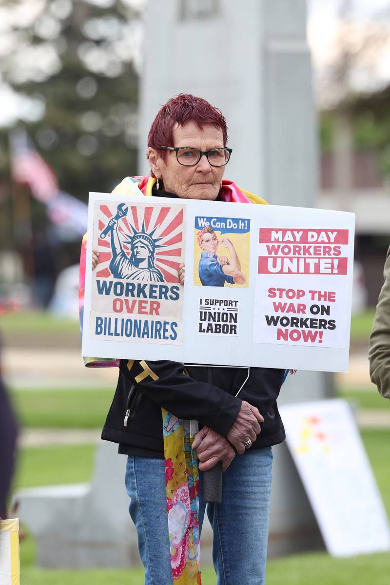 Jeanne Kent, of St. Anne, holds a sign with messages on labor rights during the May Day Strong rally at the Kankakee County Courthouse on May 1, 2026, as part of a national day of action.