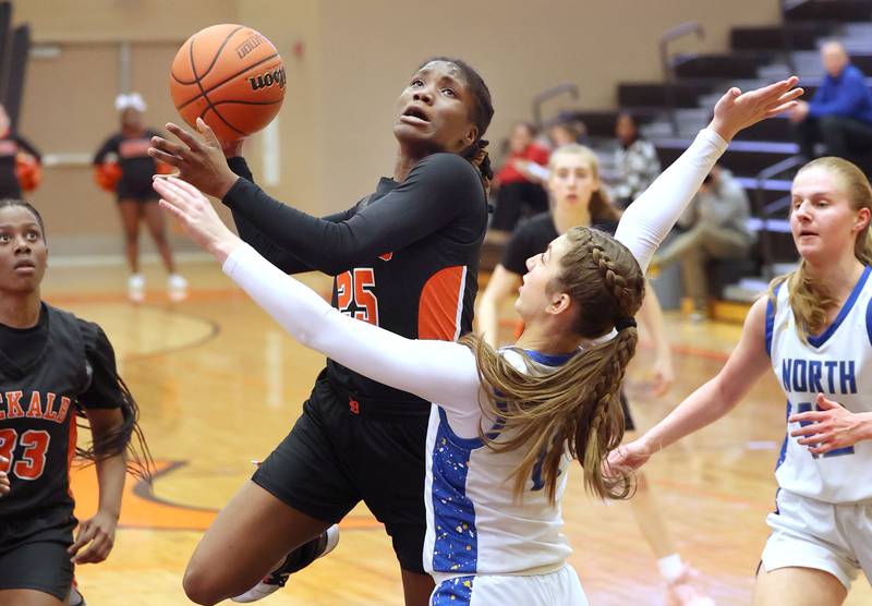 DeKalb’s Kezaria Mitchell shoots over Wheaton North's Adeline Sutton during their Class 4A regional game Monday, Feb 12, 2024, at DeKalb High School.