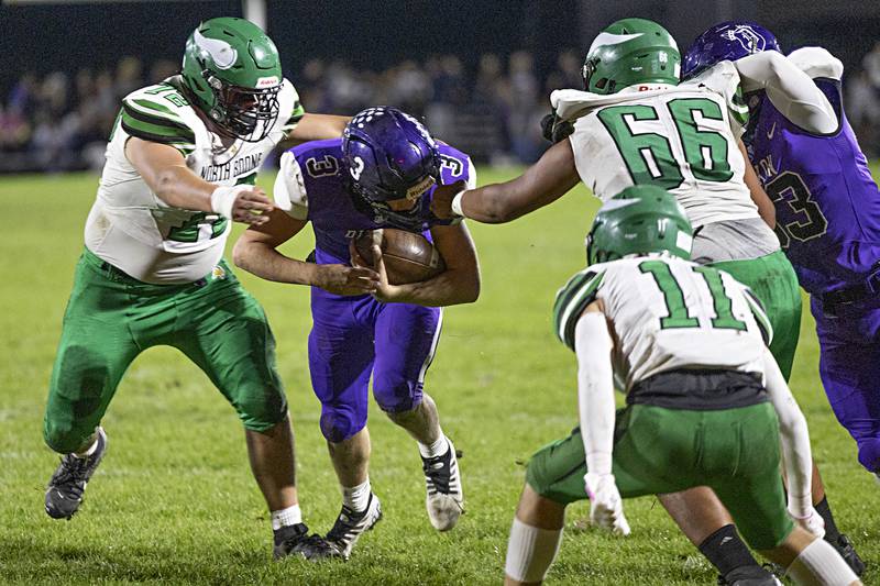 Dixon’s Tyler Shaner has his facemark held by North Boone’s Dominick Rayas Friday, Oct. 20, 2023 in Dixon.