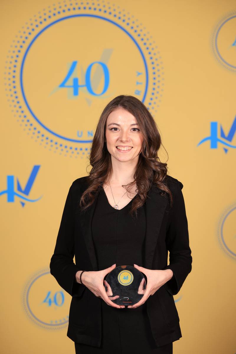 Caitlyn Tucker poses with her 40 Under Forty award during the Illinois Valley Chamber of Commerce Champions of Change Awards Night on Thursday, April 10, 2025 at the Westclox Event Center in Peru.