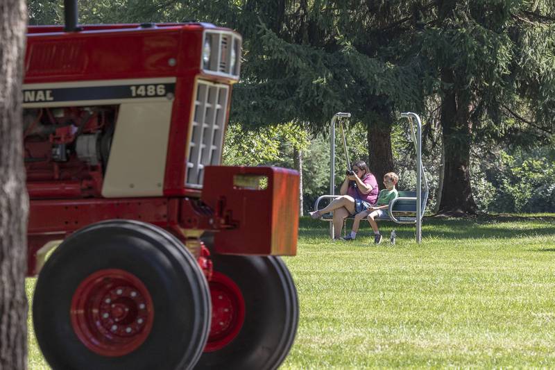 Marcus Feldbusch, 8, and mom Katie Fane snap pictures of the tractor parade Saturday, Aug. 31, 2024, in the pinetum at Lowell Park in Dixon.
