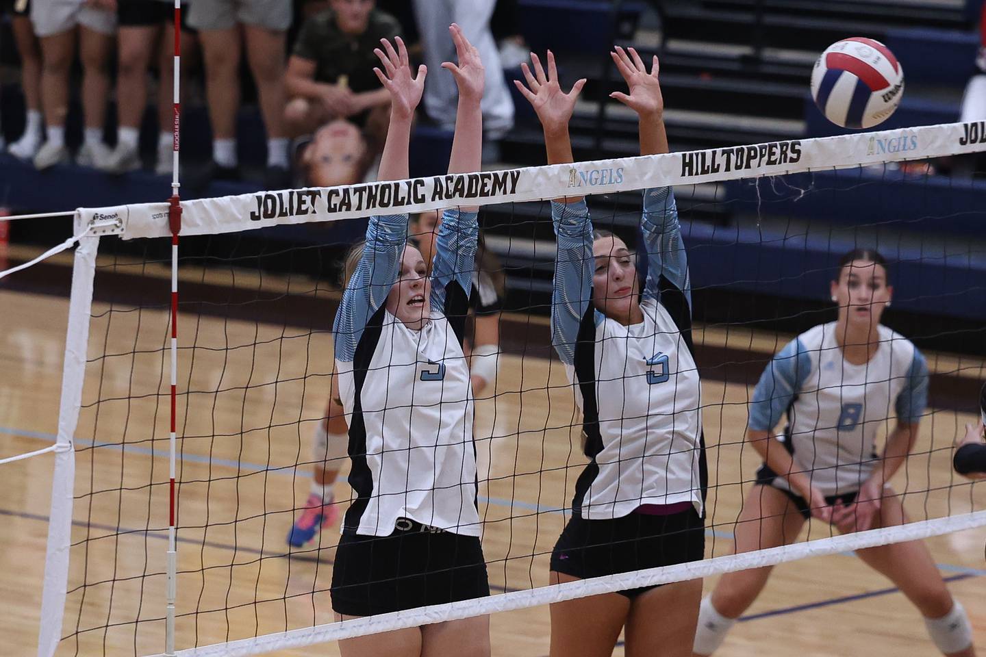Joliet Catholic's Brooke Simon, left, and Delani Kirstein go for the block against Lincoln-Way East on Monday, Sept. 23, 2024 in Joliet.
