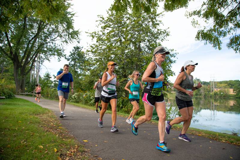Fox Valley Marathon runners run next to the Fox River at Bennet Park in Geneva on Sunday, Sept. 18, 2022.