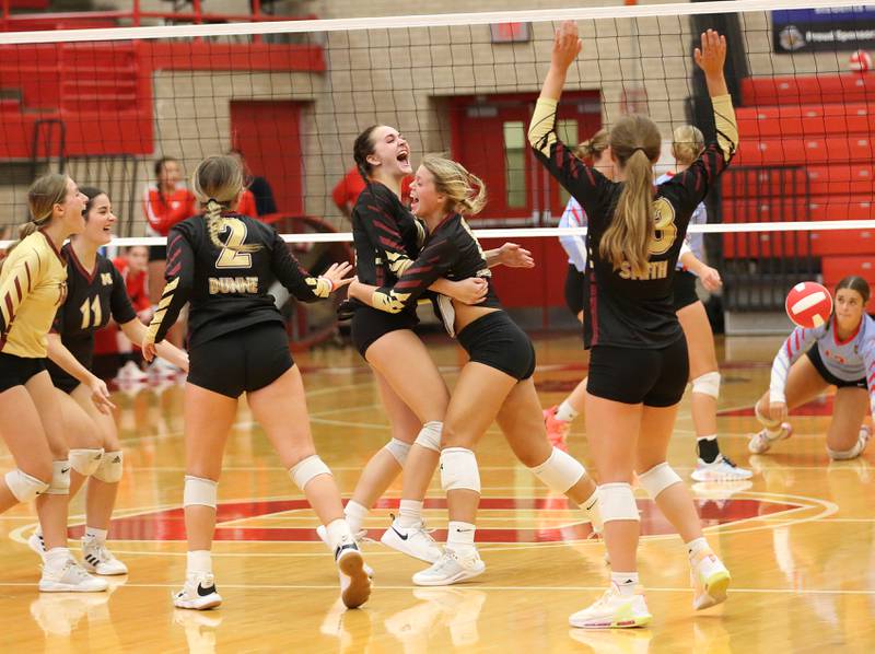 Members of the Morris volleyball team celebrate after defeating Ottawa on Tuesday, Sept. 12, 2023 in Kingman Gym at Ottawa High School.