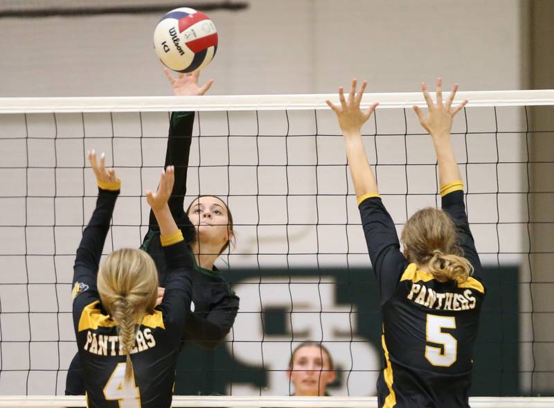 St. Bede's Mary Quinn McClain sends a kill past Putnam County's Chloe Andersen and teammate Cadence Coleman on Tuesday, Sept. 24, 2024 at St. Bede Academy.