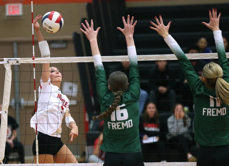 Huntley's Diellza Sejdini tries to spike the ball by Fremd’s Sasha Sallade (left) and Natasa Radisic Monday, Nov. 11, 2024, during their Class 4A supersectional match at DeKalb High School.