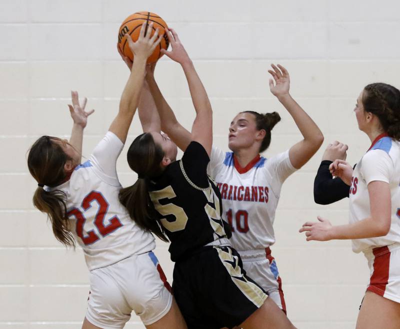 Marian Central's Jenna Remke (left) and Marian Central's Adriana Wrzos (right) block the shot of Rockford Christian's Shea Ludwig during a nononference basketball game on Monday, Feb. 10, 2025, at Marian Central High School  in Woodstock.