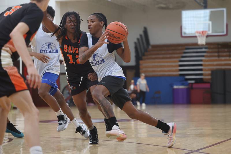 A Joliet Central player drives to the basket against DeKalb at the 37th Morris Boys Shootout on Tuesday, June 25, 2024.