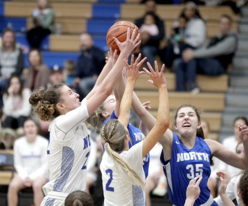 St. Charles North’s Katrina Stack (far left) grabs the rebound during the Class 4A St. Charles North Regional final against Wheaton North on Thursday, Feb. 16, 2023.