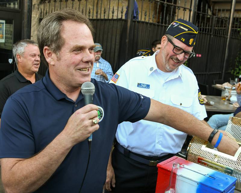 Mayor of Geneva Kevin Burns pulls the second-place winner of the 50/50 raffle at an American Legion fundraiser on Thursday Aug. 21, 2025, held at Whiskey Bend in St. Charles.