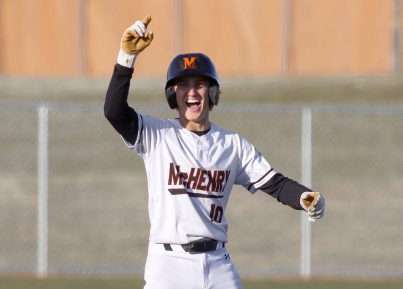 McHenry’s Jeffry Schwab celebrates at second base after connecting for a double against Huntley in varsity baseball at McHenry Friday night.