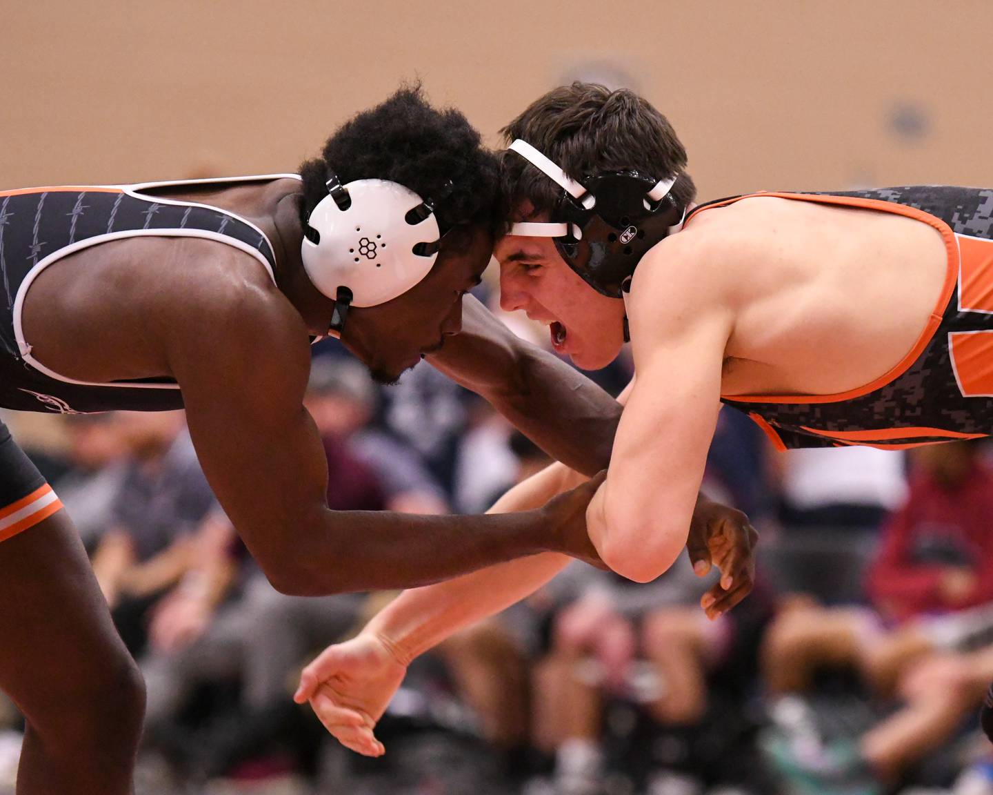DeKalb’s Cam Matthews, left, keeps a hand on Washington’s Cruise Brolley in the 165-weight class on Friday Dec. 27, 2024, during the Don Flavin invite held in DeKalb.