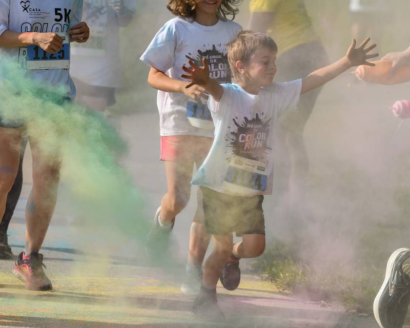 Silas Warmke is all ready to get doused with color powder as he runs through a color station on Saturday, June 7, 2025, during the CASA DeKalb County 5K Color Run held at the Sycamore Middle School.