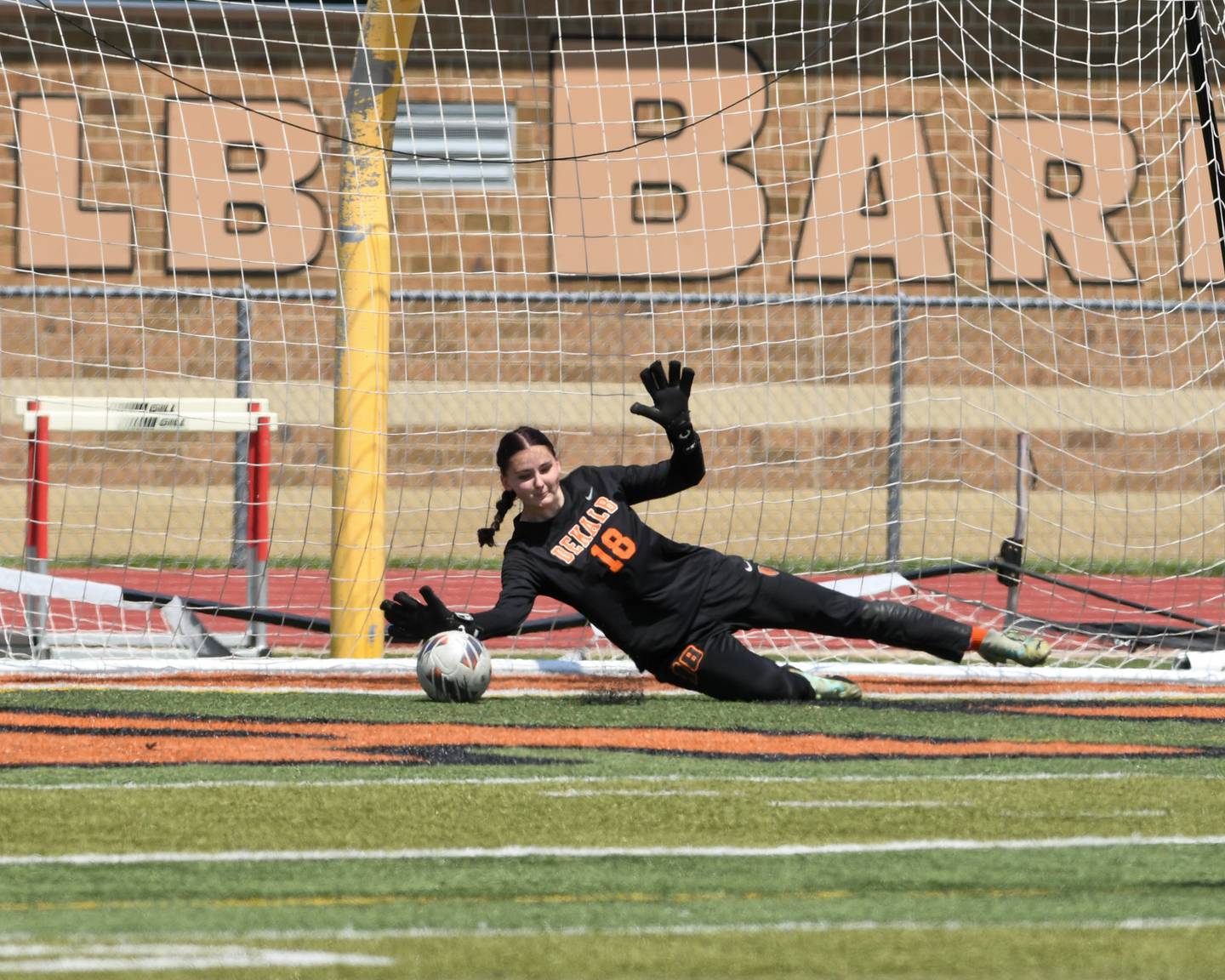DeKalb’s goalie Elizabeth Meeks makes a save on a penalty kick during the game on Saturday May 10, 2025, while taking on Sycamore held at DeKalb High School.