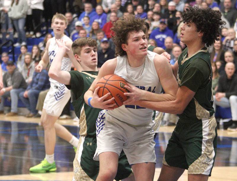 Burlington Central’s Nicholas Gouriotis works under the hoop against Rockford Boylan in IHSA Class 3A Sectional action at Burlington Central High School Wednesday night.